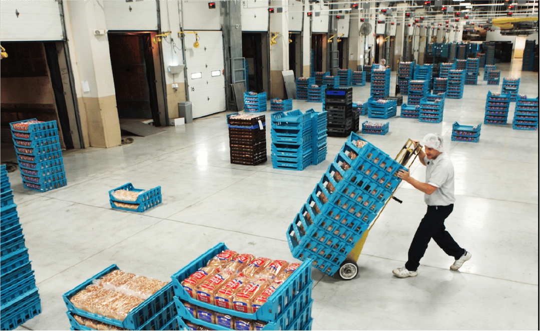 Shipping professional wheels pallets containing loaves of bread in the shipping department of the Pan-O-Gold Baking Company in St. Cloud, MN, the production site for Country Hearth Bread.