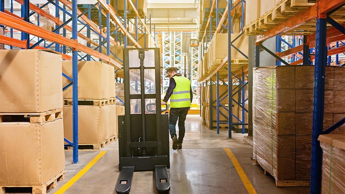 An image of a worker and a forklift in a baking shipping department. Shipping handlers also receive a comprehensive benefits package.